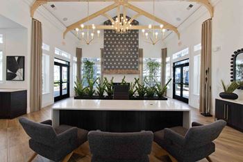 a large lobby with a table and chairs and a chandelier